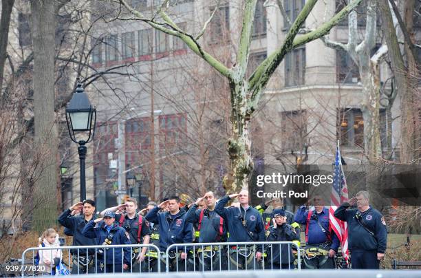 Firefighters salute during the funeral of FDNY Fire Marshal Capt. Christopher "Tripp" Zanetis in Washington Square Park March 29, 2018 in New York...