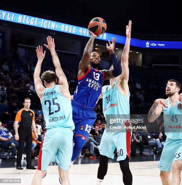 Sonny Weems, #13 of Anadolu Efes Istanbul competes with Petteri Koponen, #25 of FC Barcelona Lassa and Victor Claver, #30 of FC Barcelona Lassa...