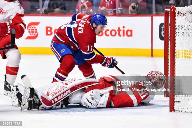 Brendan Gallagher of the Montreal Canadiens tips in the puck past goaltender Jared Coreau of the Detroit Red Wings for his thirtieth goal of the...