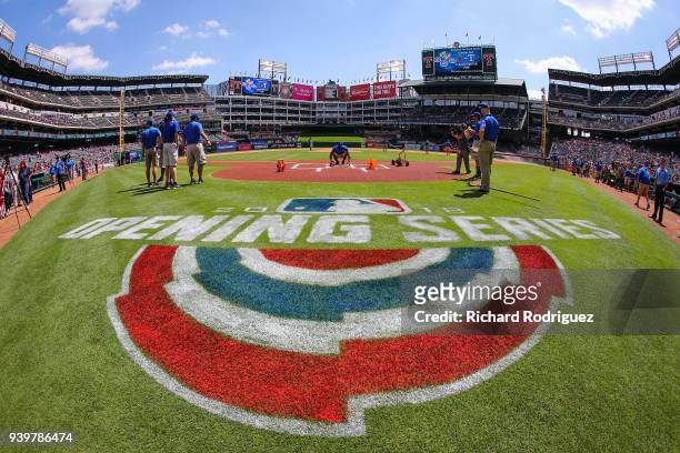 The grounds crew prepare the field for the Opening Day baseball game between the Houston Astros and Texas Rangers at Globe Life Park in Arlington on...