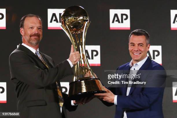 Head coach Tony Bennett of the Virginia Cavaliers is presented with the Associated Press Mens College Basketball Coach of the Year trophy by Barry...