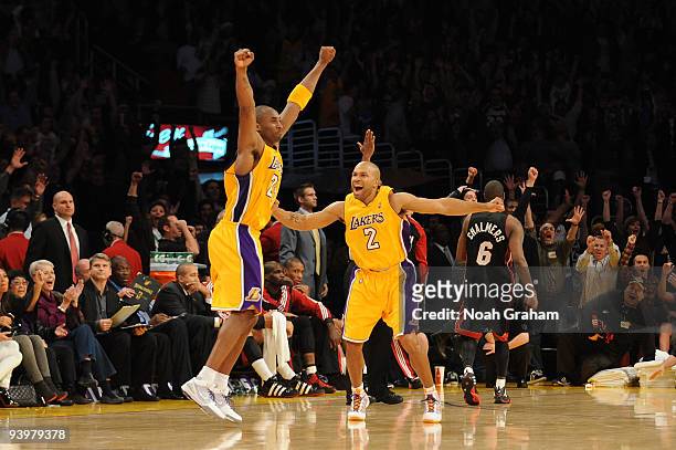 Kobe Bryant and Derek Fisher of the Los Angeles Lakers celebrate a win over the Miami Heat at Staples Center on December 4, 2009 in Los Angeles,...