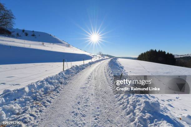 road in landscape in winter, gersfeld, rhoen mountain, hesse, germany - rhön stock-fotos und bilder