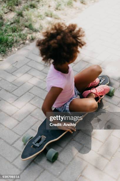 little girl sitting on the longboard - father longboard stock pictures, royalty-free photos & images