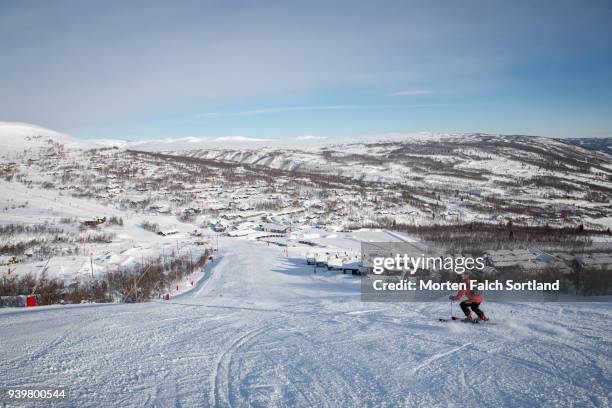 a skier on a slope in southern norway on a bright winter morning - buskerud stock pictures, royalty-free photos & images