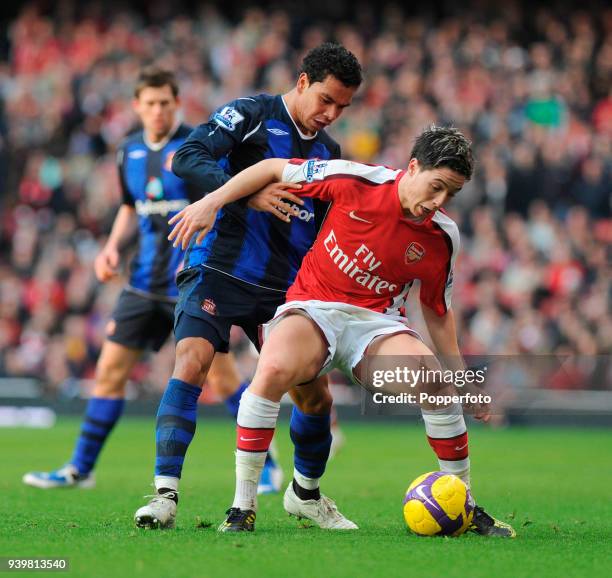 Samir Nasri of Arsenal holds off Kieran Richardson of Sunderland during the Barclays Premier League match between Arsenal and Sunderland and Arsenal...