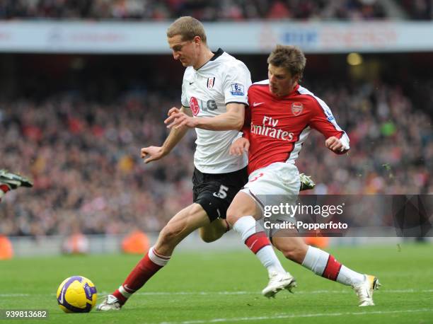 Andrey Arshavin of Arsenal challenges Brede Hangeland of Fulham during the Barclays Premier League match between Arsenal and Fulham at Emirates...