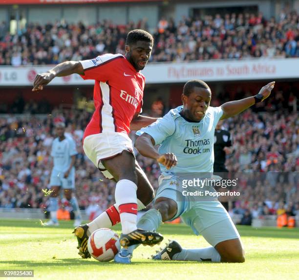 Kolo Toure of Arsenal is tackled by Nedum Onuoha of Manchester City during the Barclays Premier League match between Arsenal and Manchester City at...