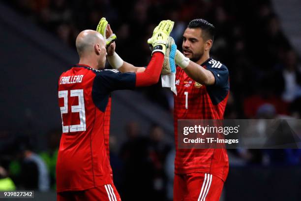 Willy Caballero of Argentina and Sergio Romero of Argentina slap hands during the international friendly between Spain and Argentina at Wanda...