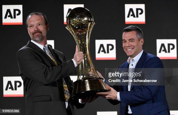 Head coach Tony Bennett of the Virginia Cavaliers is presented with the Associated Press Men's College Basketball Coach of the Year trophy by Barry...
