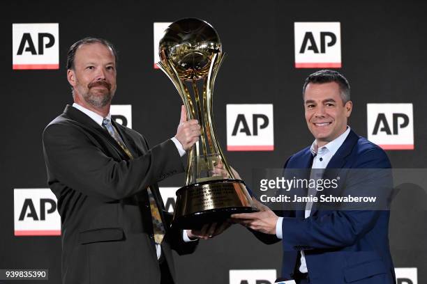 Head coach Tony Bennett of the Virginia Cavaliers is presented with the Associated Press Men's College Basketball Coach of the Year trophy by Barry...