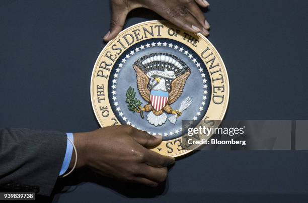 The presidential seal is affixed to a podium before U.S. President Donald Trump, not pictured, speaks during an event at the Local 18 Richfield...