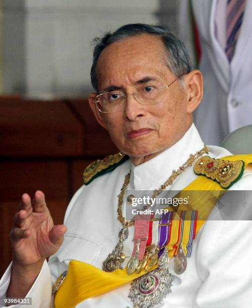 Thai King Bhumibol Adulyadej waves to a crowd of well-wishers as he leaves the Siriraj Hospital in Bangkok on December 5, 2009. Thailand's revered...