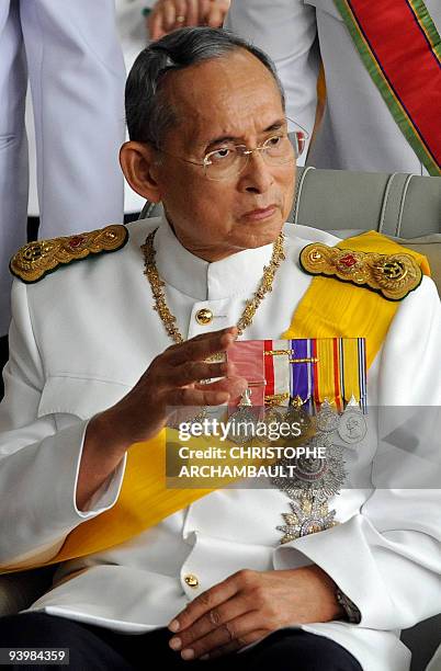 Thai King Bhumibol Adulyadej waves to a crowd of well-wishers as he leaves the Siriraj Hospital in Bangkok on December 5, 2009. Thailand's revered...