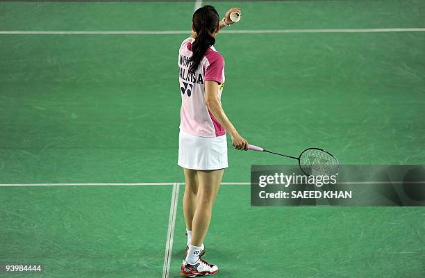 Wong Mew Choo of Malaysia serves to Yao Jie of the Netherlands in the first women's semi-final match at the Badminton World Super Series Masters...