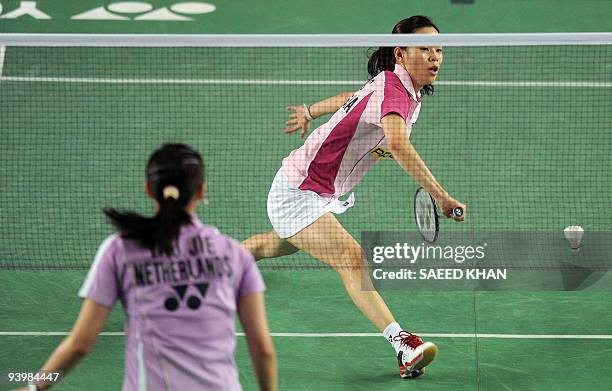 Wong Mew Choo of Malaysia reaches for a return against Yao Jie of the Netherlands during their first women's semi-final match at the Badminton World...