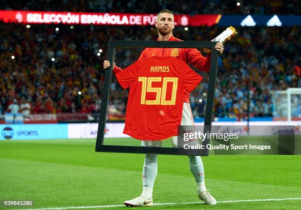 Sergio Ramos of Spain poses with a special framed jersey marking his 150th cap for Spain prior to the international friendly match between Spain and...