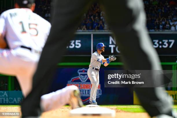 Tommy La Stella of the Chicago Cubs hits an RBI double in the seventh inning during the Opening Day against the Miami Marlins at Marlins Park on...