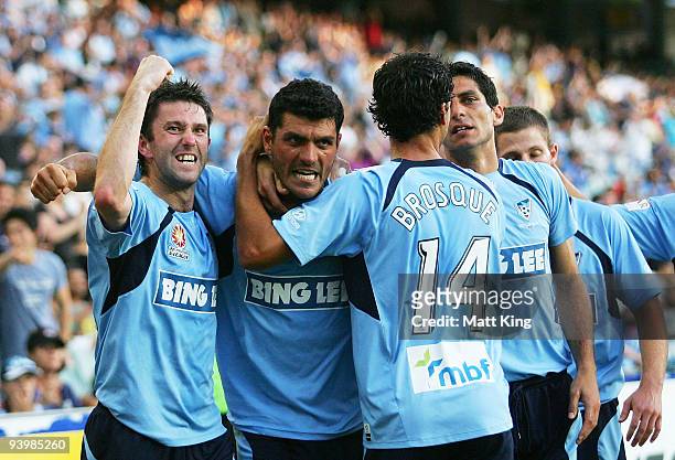 John Aloisi of Sydney celebrates scoring a first half goal with Terry McFlynn and Alex Brosque during the round 17 A-League match between Sydney FC...