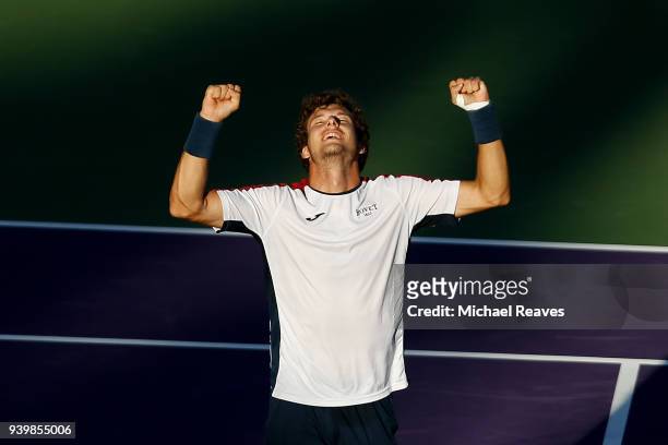 Pablo Carreno Busta of Spain celebrates match point against Kevin Anderson of South Africa during their quarterfinal match on Day 11 of the Miami...