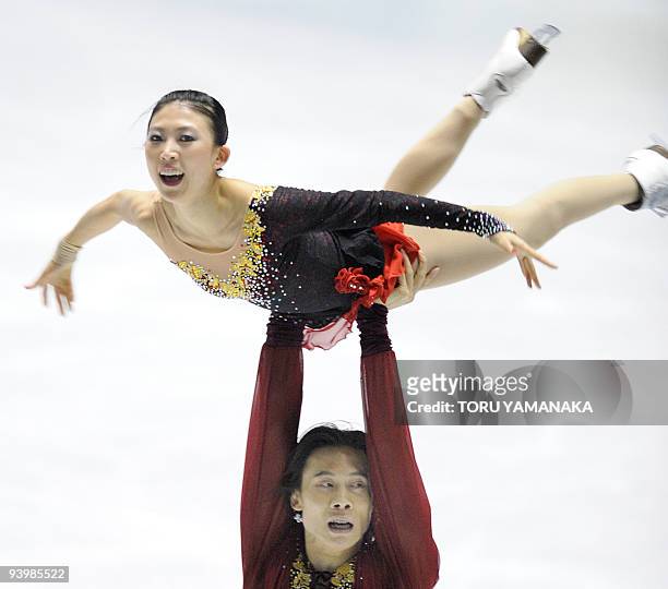 Chinese Tong Jian lifts his partner Pang Qing during the free skating of the pair's competition in the figure skating ISU Grand Prix Final in Tokyo...