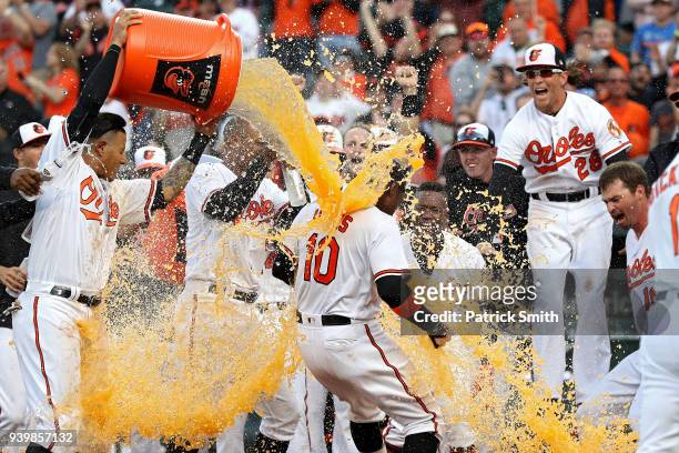 Adam Jones of the Baltimore Orioles celebrates with teammates after hitting a walk-off home run against the Minnesota Twins during the eleventh...