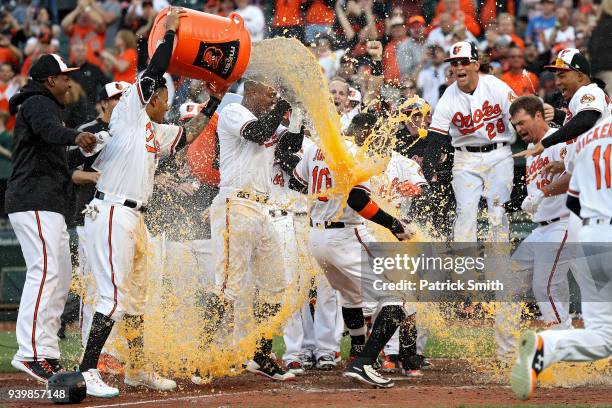 Adam Jones of the Baltimore Orioles celebrates with teammates after hitting a walk-off home run against the Minnesota Twins during the eleventh...