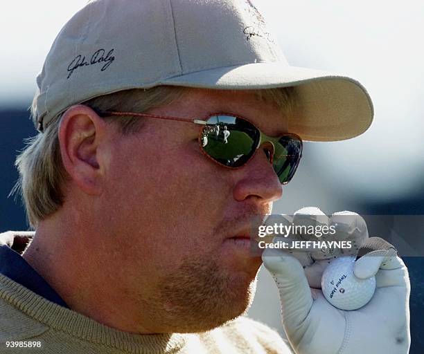 Golfer John Daly of the US smokes a cigarette 05 April, 2000 on the 10th tee before the final practice round for the 2000 Masters Golf Tournament at...