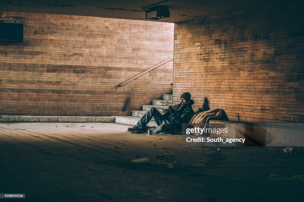 Beggar playing guitar