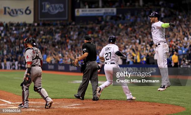 Carlos Gomez and Kevin Kiermaier of the Tampa Bay Rays react after scoring on a triple by Denard Span in the eighth inning during a game against the...