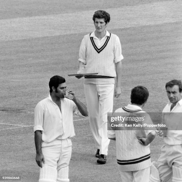 Bob Willis of Surrey carries the drinks tray during a drinks break in the 2nd tour match between England and Rest of the World at Trent Bridge,...