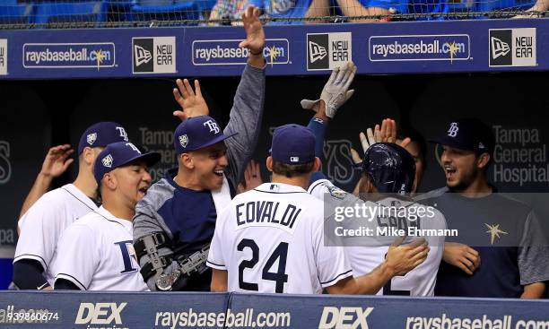 Denard Span of the Tampa Bay Rays is congratulated after hitting a three run triple in the eighth inning during a game against the Boston Red Sox on...