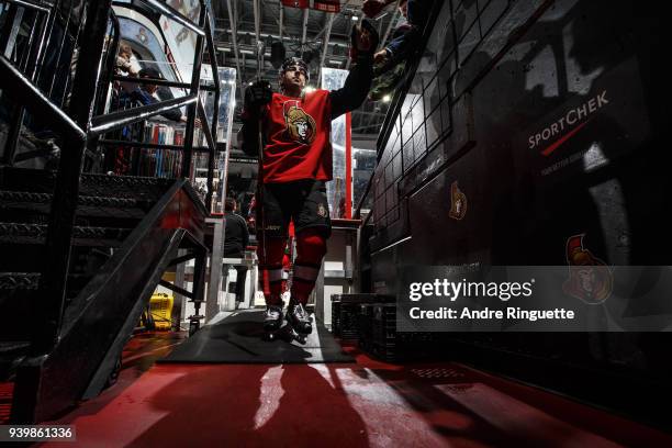 Jean-Gabriel Pageau of the Ottawa Senators high-fives a fan as he leaves the ice after warmup prior to a game against the Florida Panthers at...