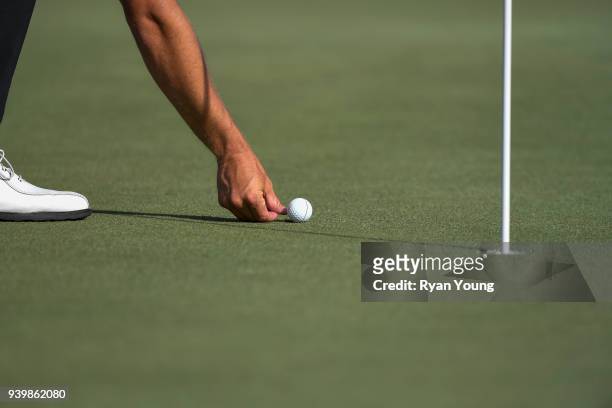 Player marks his ball after hitting a close shot during the first round of the Web.com Tour's Savannah Golf Championship at the Landings Club Deer...