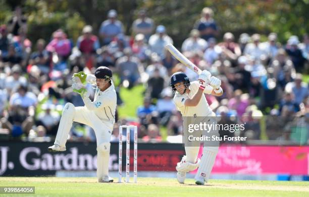 England batsman Joe Root hits out watched by BJ Watling during day one of the Second Test Match between the New Zealand Black Caps and England at...