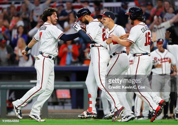 Nick Markakis of the Atlanta Braves celebrates with Dansby Swanson, Ryan Flaherty and Charlie Culberson after hitting a three-run homer in the ninth...