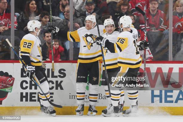 Conor Sheary of the Pittsburgh Penguins celebrates his first period goal with Matt Hunwick, Riley Sheahan and Dominik Simon during the game against...