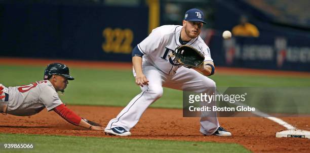 Boston Red Sox player Mookie Betts is picked off of first base in the top of the eighth inning as Rays' first baseman C.J. Cron takes the throw from...