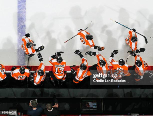 Travis Konecny, Claude Giroux and Brandon Manning of the Philadelphia Flyers celebrate one of Konecny's two goals against the New York Rangers with...