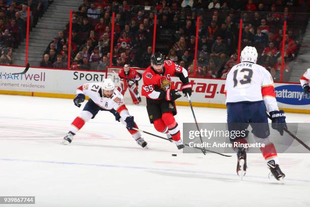 Erik Karlsson of the Ottawa Senators controls the puck against Vincent Trocheck of the Florida Panthers at Canadian Tire Centre on March 29, 2018 in...