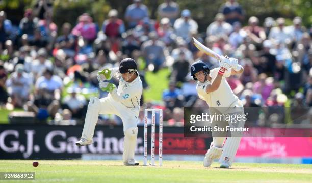 England batsman Joe Root hits out watched by BJ Watling during day one of the Second Test Match between the New Zealand Black Caps and England at...