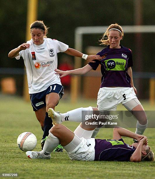 Julianne Sitch of the Victory and Shannon May of the Glory contest the ball as Tanya Oxtoby lies injured on the pitch during the round 10 W-League...