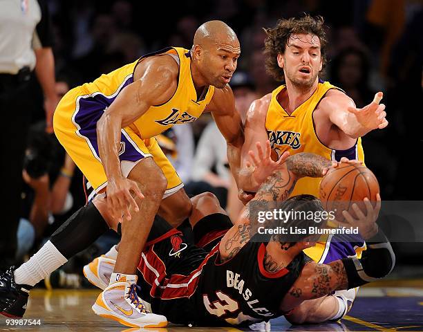 Derek Fisher and Pau Gasol of the Los Angeles Lakers try to get the ball from Michael Beasley of the Miami Heat at Staples Center on December 4, 2009...