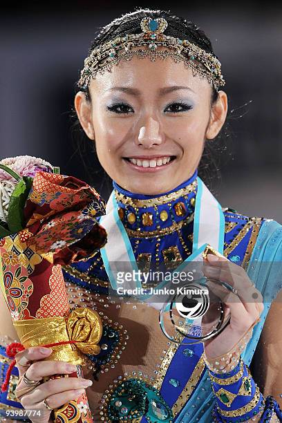 2nd placed Miki Ando of Japan poses with her medal after competing in the Ladies Free Skating on the day three of ISU Grand Prix of Figure Skating...