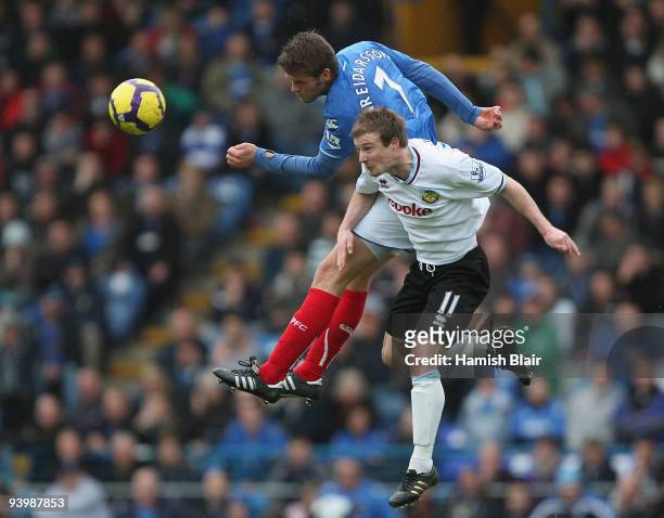 Hermann Hreidarsson of Portsmouth contests the ball with Wade Elliott of Burnley during the Barclays Premier League match between Portsmouth and...