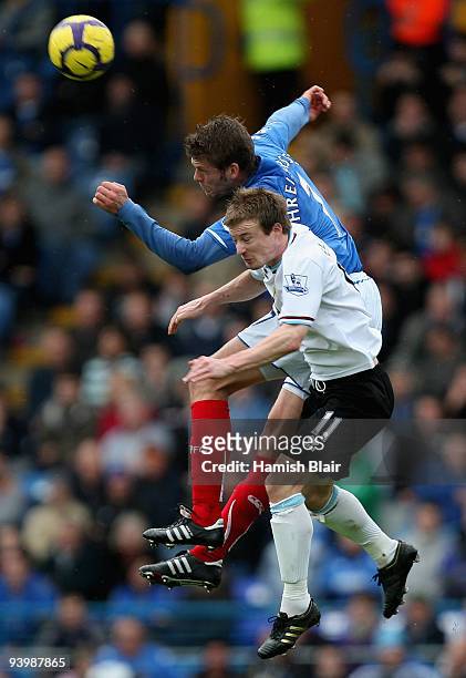 Hermann Hreidarsson of Portsmouth contests the ball with Wade Elliott of Burnley during the Barclays Premier League match between Portsmouth and...