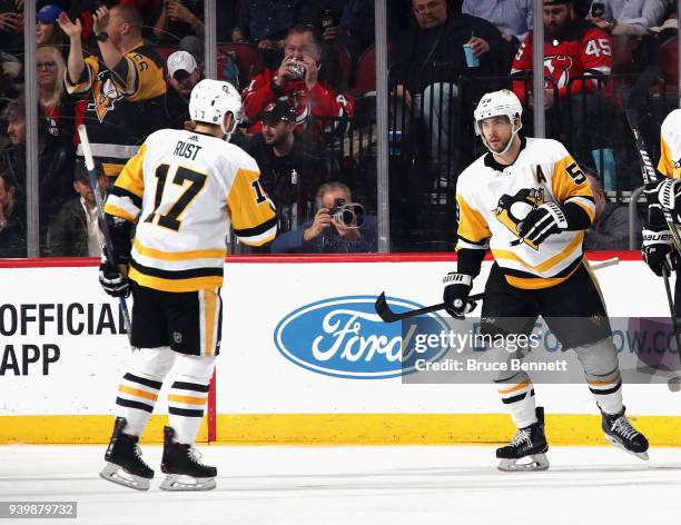 Kris Letang of the Pittsburgh Penguins celebrates his goal at 6:59 of the second period against the New Jersey Devils and is joined by Bryan Rust at...