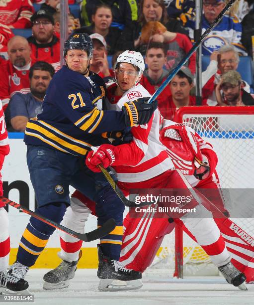 Danny DeKeyser of the Detroit Red Wings defends against Kyle Okposo of the Buffalo Sabres during an NHL game on March 29, 2018 at KeyBank Center in...