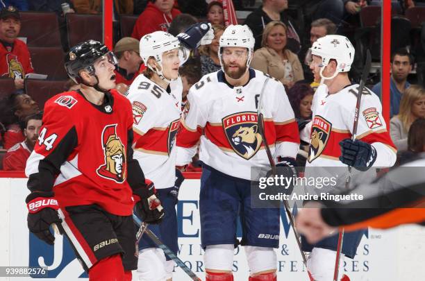 Aaron Ekblad of the Florida Panthers celebrates his second period goal with teammates Henrik Borgstrom and Mike Matheson as Jean-Gabriel Pageau of...