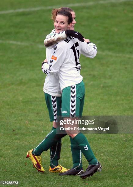 Simone Laudehr of Duisburg celebrates after scoring her team's third goal with team mate Femke Maes during the Women's Bundesliga match between FCR...